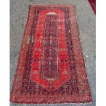 A Hamadan rug, the red field decorated with birds and an Herati pattern medallion, 311 x 159cm.