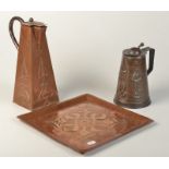 A Hayle copper Art Nouveau jug, one other jug and an Arts and Crafts tray.