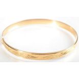 A single 18ct. gold bangle 11.9g. Condition report: Very minor misshaping.
