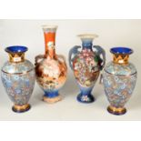 A pair of Royal Doulton Slater patent vases with blue textured floral enamel bodies beneath a leaf