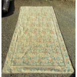 A Greek Needlepoint rug, the cream ground decorated with rows of flowering vines,