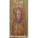 A Samarkand runner, the beige ground with a polychrome medallion within two borders, 235 x 67cm.