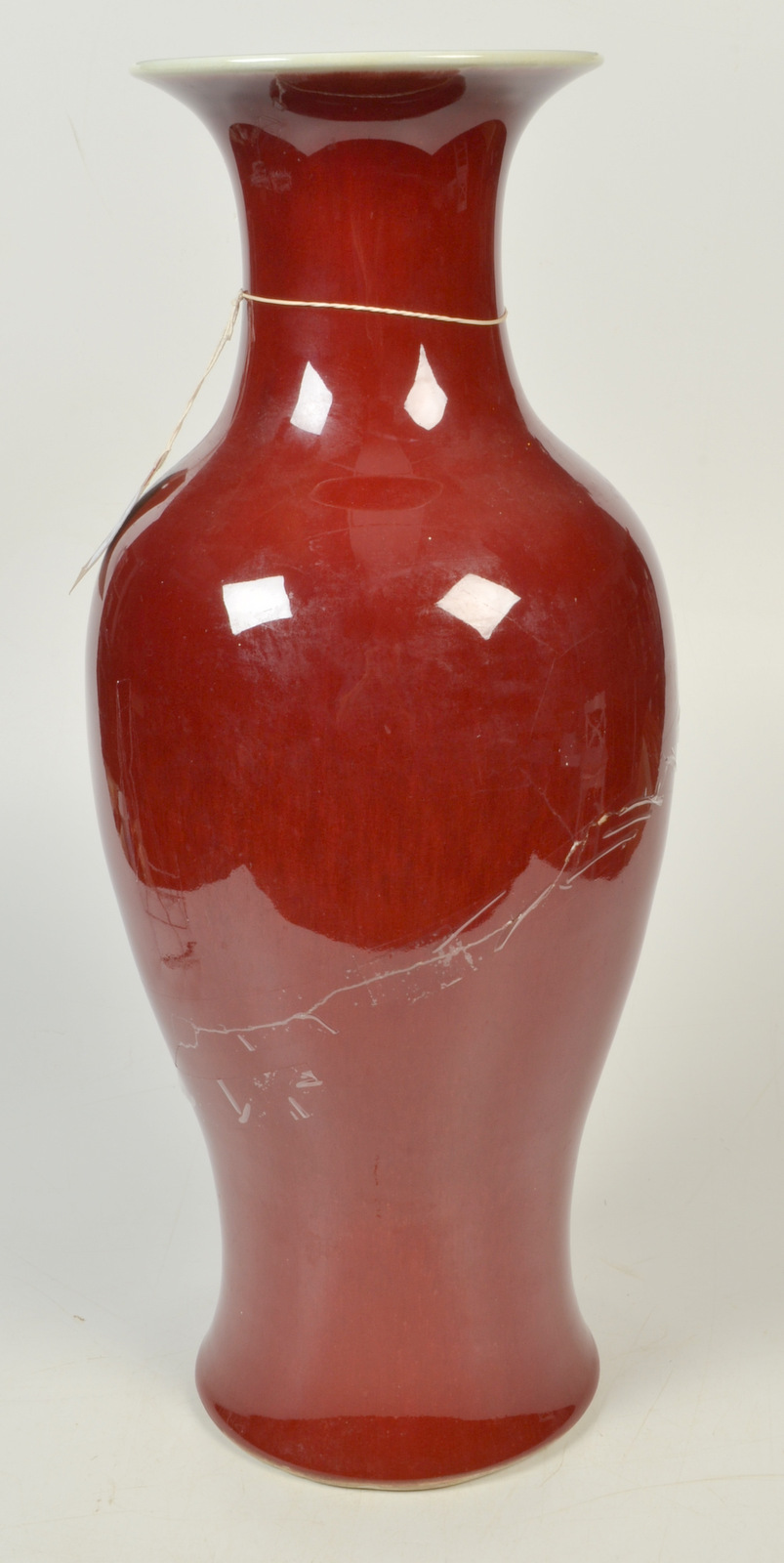 A large Chinese baluster vase in sang de boeuf glaze, the flared neck with flambe decoration,
