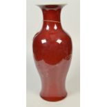 A large Chinese baluster vase in sang de boeuf glaze, the flared neck with flambe decoration,