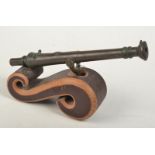 A Brunei bronze Lantaka small swivel cannon on a wooden scroll base, full length 31cm.