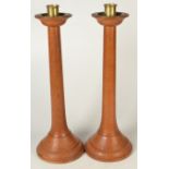 A pair of Arts and Crafts turned light oak candlesticks.