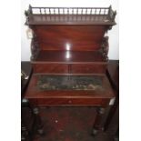 A mid 19th century continental mahogany bonheur du jour with spindle turned gallery on scrolling