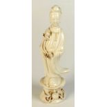 A Chinese blanc de chine figure of Quanyin standing on a floral decorated pedestal,