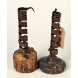 Two spiral iron candlesticks.