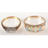 An 18ct. gold three stone diamond ring and a 9ct. gold ring set with opals.