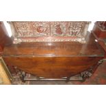 An early 18th century oak gate leg oval dining table fitted two drawers.