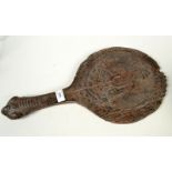 An Indian carved wood panel depicting Hanuman, monkey god, in the form of a paddle, length 53cm,