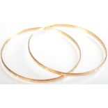A pair of 18ct. gold bangles 13.1g. Condition report: Very minor misshaping.