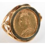 A 9ct. gold ring set with a Victorian shield back half sovereign 1892, 9.8g.