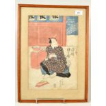 A 19th century Japanese woodcut print of a room interior where an actor sits,