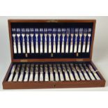 A good set of eighteen Victorian dessert knives and forks with engraved blades and mother of pearl