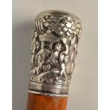 A Chinese walking cane with silver handle decorated with oriental figures, trees and pagodas,