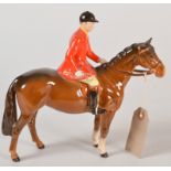 A Beswick equestrian group with a huntsman on a brown hunter.