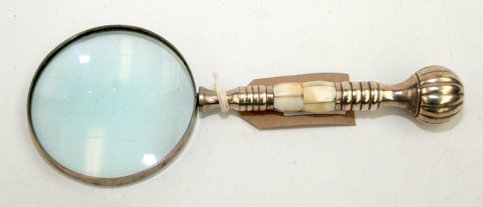 A silver plated mother of pearl mounted magnifying glass, full length 26cm.