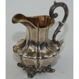 A William IV pear form lobed milk jug, cast feet and handle, the interior gilt, by the Barnards,