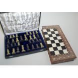 An Indian inlaid hardwood chess board/box and a soapstone chess set.
