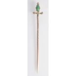 A gold sword pin with jade and diamond finial.