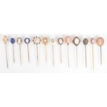 Twelve pins, each mounted with a small cameo.