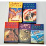 Four Harry Potter hardback books, each the first edition with dust jacket,