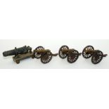 A set of three brass model cannon each with cast iron carriage,