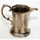 An early Victorian octagonal section silver milk jug with chased floral and foliate decoration, 5oz.