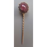 A gold mounted star ruby stick pin.