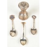 A silver mounted pepper mill and three silver plated spoons.