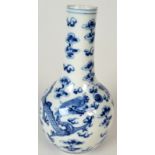 A Chinese blue and white porcelain bottle vase decorated with a pair of dragons chasing the flaming