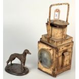 A signalling lamp, together with a dog sculpture.