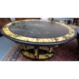 An oval ebonised dining table painted to simulate tortoiseshell inlay on four shaped legs,