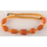 An necklace of seven principal amber beads and other beads. Total weight 46.3g.