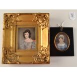 A mid to early 19th century English portrait miniature of a young lady, her black hair in ringlets,