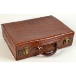 A small leather suitcase simulating crocodile.