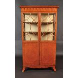 A Sheraton revival satinwood display cabinet of exceptional quality,