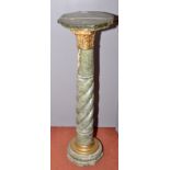 A green marble pedestal with an octagonal top on a brass Corinthian capital,