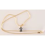 A pear shaped black pearl pendant on 14ct. gold snake necklace.