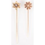 A French flower head gold pin set a pearl and a flower head pin set a diamond.