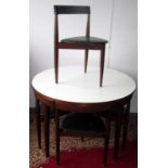 A Danish rosewood circular table and four matching chairs designed by Hans Olsen for Frem Rojle,
