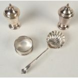 A pair of conical pepper pots, a silver napkin ring and a late Victorian silver sugar casting spoon.