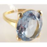 An 18ct. gold ring set a blue stone.