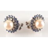 A pair of 18ct. white gold pearl, diamond and sapphire cluster earrings.