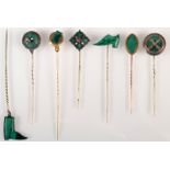 Malachite, two gold mounted pins and five silver mounted pins.