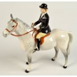 A Beswick huntswoman on a grey horse. No damage noted.