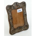 A silver mounted Edwardian photograph frame embossed with winged heads.