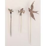 A pin, the bird finial set with two diamonds,